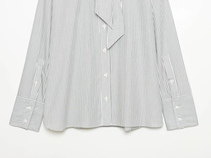 Detail of a women striped poplin shirt featuring a scarf-neck tie and button-up front