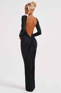 Detail of elegant backless design on a slim-fit black long-sleeve evening maxi dress