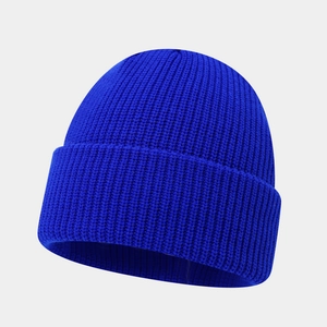 Close-up detail of the royal blue ribbed knit texture on the thick winter beanie cap