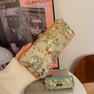 Detail of floral embroidery on a retro Japanese style fabric pencil case and organizer