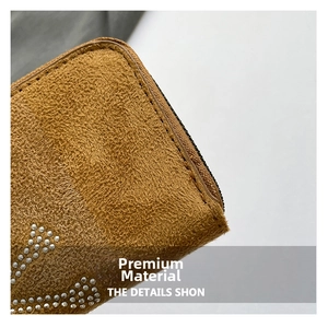 Macro view of brown suede texture with silver studs and smooth metal zipper details