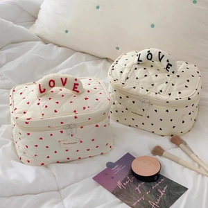 Quilted heart cosmetic bag with LOVE embroidery handle and stylish storage compartments