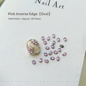 Macro shot of 3x4mm pink oval flatback nail art zircons on a white display card