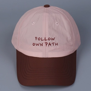 Detail of FOLLOW OWN PATH embroidery on two-tone breathable lightweight baseball cap