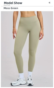Detail view of high-waisted moss green yoga pants with seamless waistband and matte finish