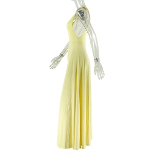 Detail view of bright yellow halter neck sleeveless dress with open back and ruched waist