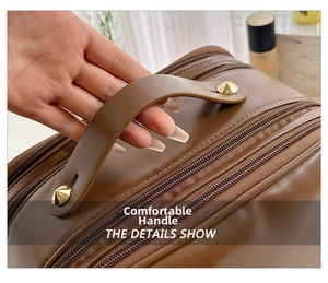 Macro shot of comfortable leather handle with gold rivets and dual zipper detail