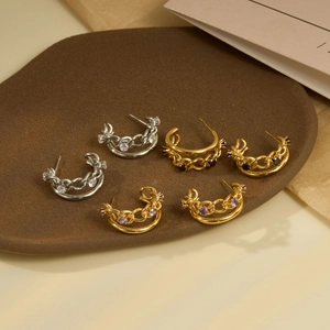 Three pairs of geometric C-shaped hoop earrings with layered chain texture and zircon stones