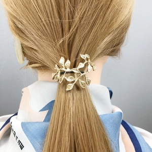 Golden leaf hair cuff ponytail holder on model for elegant minimalist hairstyling