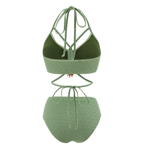 Detailed view of sage green bohemian bikini set featuring fringe and textured fabric