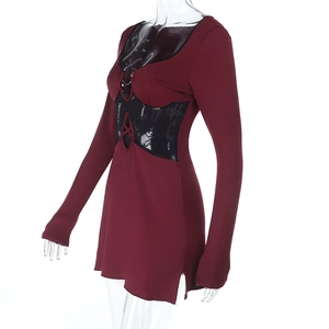 Detail of burgundy long sleeve mini dress featuring black lace patchwork and hollow out V-neck