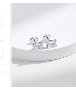 Macro detail of S925 sterling silver rectangular earrings with emerald cut cubic zirconia