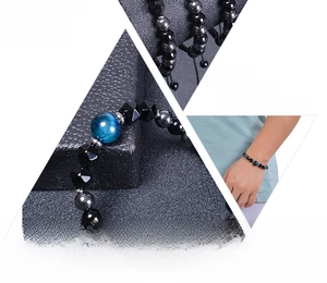 Detail view of 8mm natural tiger eye stone beads and black magnetic stone woven bracelet