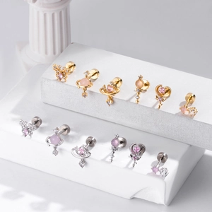 Detailed view of pink zircon earrings with butterfly and star motifs on stone steps