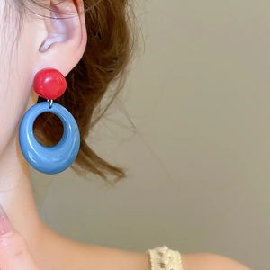 Minimalist resin drop earrings featuring bold red studs and blue circular hoop pendants