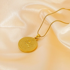 Golden Leo zodiac coin pendant necklace with relief carving on champagne silk background
