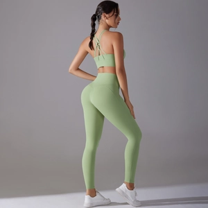 Detail of mint green yoga set featuring cross-back sports bra and high-waisted leggings