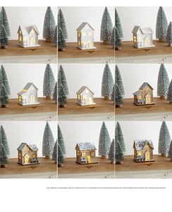 Detail view of mini glowing wooden Christmas houses with snow-covered roofs and tiny windows
