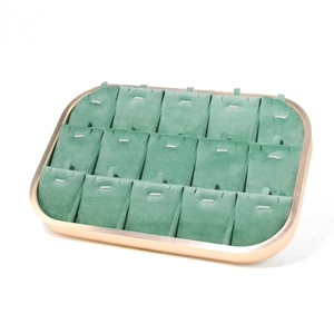 Detail view of 15-slot green velvet jewelry display tray with elegant gold metal frame
