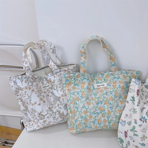 Detailed view of three minimalist floral canvas tote bags with simple wish logo labels