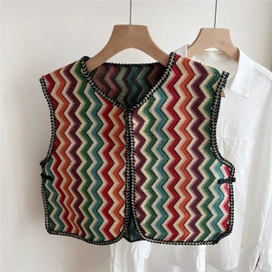 Detail view of multi-color wavy knit vest with contrast black trimmed edges and collar