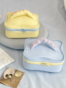 Padded macaron cosmetic bags with handle, contrast zipper and embroidery