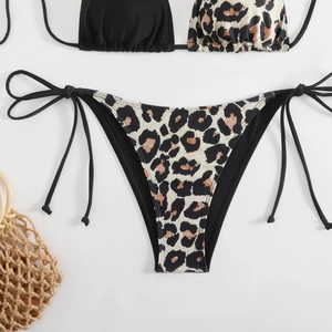 Detail of zebra print bikini with side-tie bottoms and textured black fabric contrast