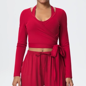 Detail of red long sleeve wrap yoga top and drawstring wide leg sports trousers