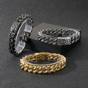 Macro detail of vintage hammered Cuban link bracelets in gold, silver, and black finishes