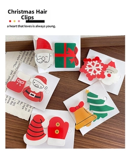Detail of Christmas hair clip set with Santa Claus and festive tree charms on cards