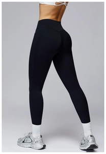 Detail of high-waist black yoga leggings featuring ergonomic seams and V-shaped back stitching