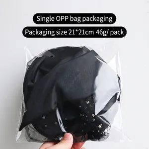 Detail view of the star and moon pattern on the mesh fabric witch hat in OPP packaging