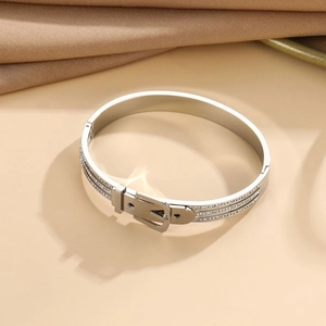 Close-up of belt buckle style stainless steel bangle with Fashion engraving and rhinestones