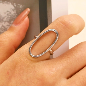 Macro shot of silver hollow oval geometric ring with polished minimalist metal lines