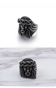 Macro shot of vintage steel ring featuring detailed tribal chief carving and textured finish
