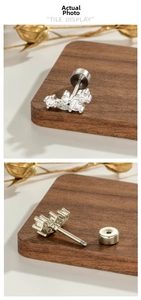 Macro detail of silver geometric marquise zircon ear stud with secure screw back closure