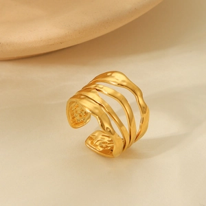 Close-up of golden multi-layered wavy open ring with high-quality polished metal texture