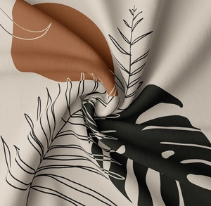 Detail of soft fabric tapestry showing monstera leaf print and natural draped texture