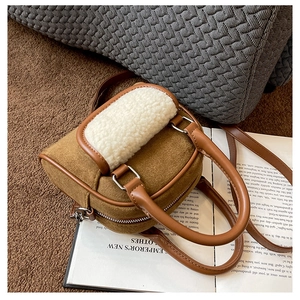 Detail of caramel velvet tote with white faux shearling trim and PU leather straps