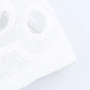 Detailed view of French white hollow embroidery fabric with delicate floral lace patterns