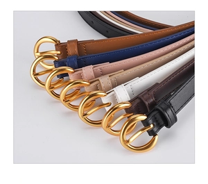 Detailed display of assorted women's leather belts with elegant golden round buckles