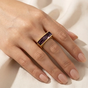 Close-up of gold stainless steel ring featuring a luxury purple rectangular gemstone