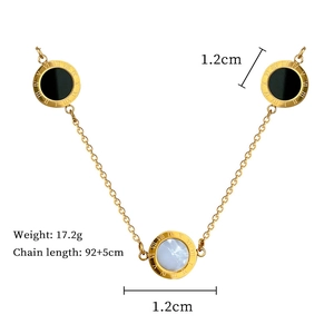 Detail of gold titanium steel necklace with Roman numeral pendants and mother of pearl