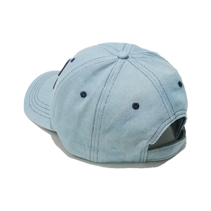 Rear view of light blue denim baseball cap with adjustable strap and detailed stitching