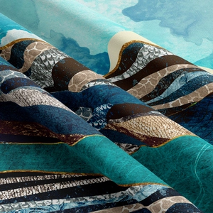 Close-up of high-density fabric texture showing abstract blue and gold mountain pattern