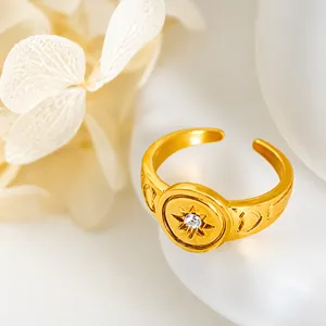 Close-up of golden adjustable ring with sunburst pattern and heart embossing details