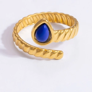 Detailed close-up of 18k gold rope band ring featuring a blue pear-shaped natural stone