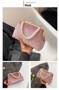 Detail of pink velvet evening bag with pearl handle, diamond quilting and gold chain