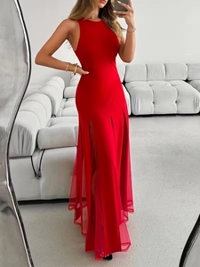 Detail of red sleeveless gown featuring mesh sheer hem and side slit design