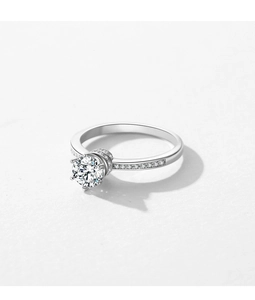 Macro shot of silver crown ring with brilliant round center diamond and side accents
